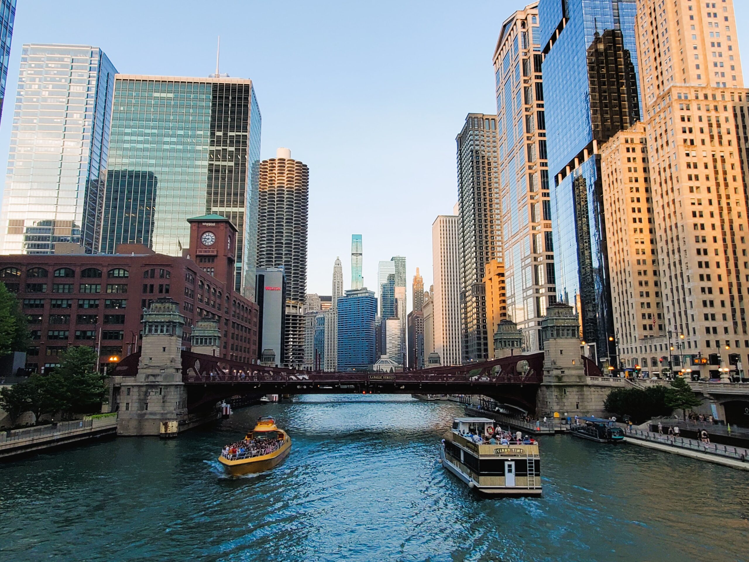 Chicago riverwalk with skyscrapers, boats and historic bridges